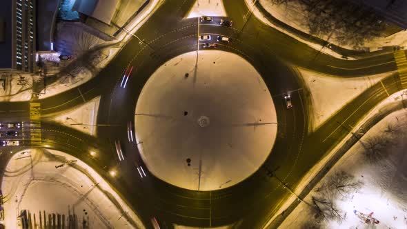 Illuminated Traffic Circle in the City and Cars at Winter Night alt