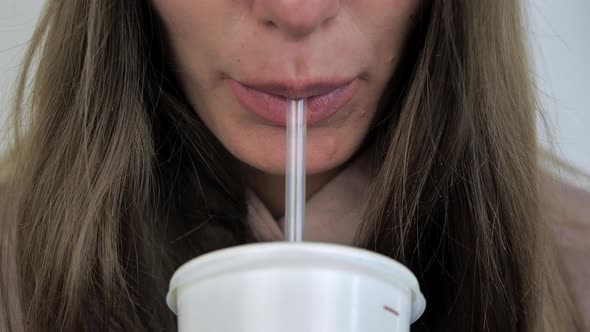Closeup of the Woman s Lips Drinking a Beverage From a Tube alt