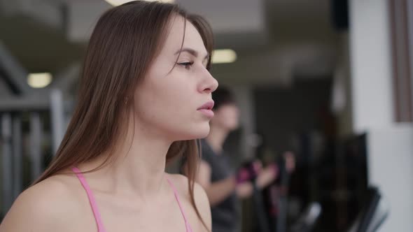 Sexy Girl is Engaged in Sports Orbitrek Simulator alt