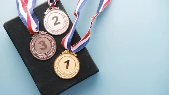 First Place Throphy and a Book on Light Color Background alt