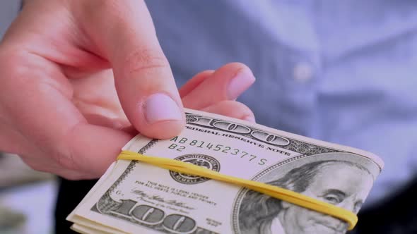 Business Woman Displaying a Spread of Cash US Dollars alt