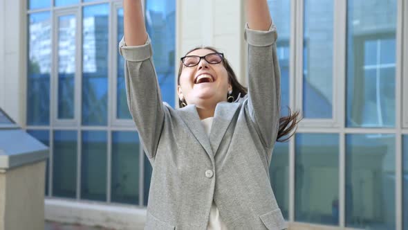 Woman in a Business Suit Walks and Happily Throws Up Documents on the Street Slow Motion alt