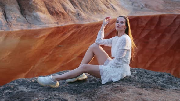 Beautiful woman posing on other-worldly hilly landscape