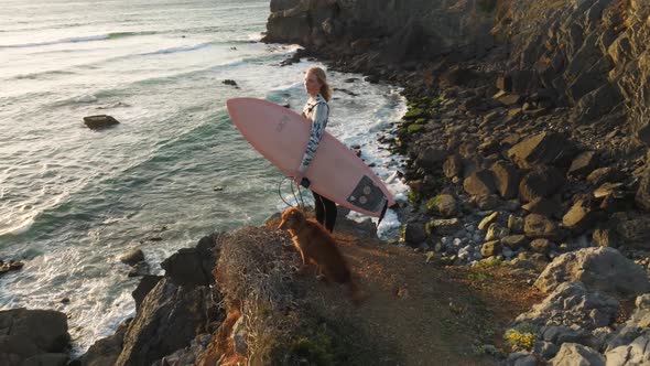 4k drone close up Slow motion Surfer with board. Slim woman in swimsuit looking at the beach on the alt
