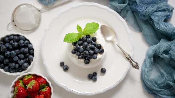 Delicious Mini Pavlova Meringue Nest with Blueberry and Mint Leaves