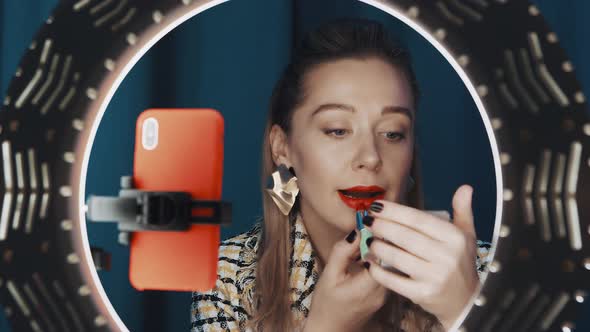Woman Applying Red Lipstick Recording Tutorial Video