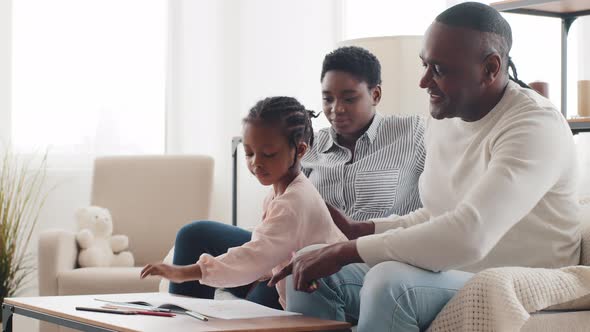 Afro American Mixed Race Ethnic Family African Parents and Little Daughter Toddler Child Sitting at alt