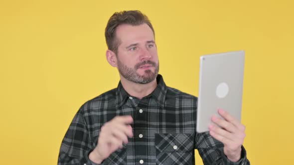 Portrait of Middle Aged Man Celebrating on Tablet in Office alt