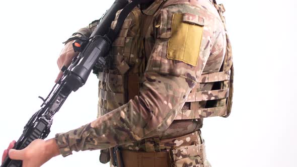 Special Forces scout wearing a multicam tactical outfit with a flak jacket and a combat rifle