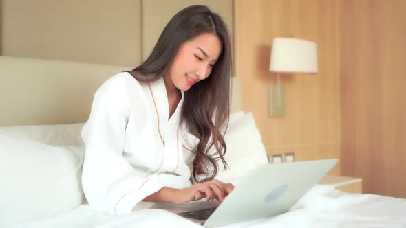 Young asian woman use laptop alt
