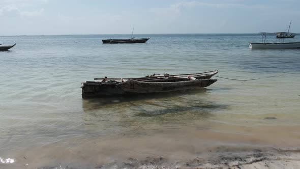 Old Dry African Fishing Rowboat Anchored on Beach at Low Tide Zanzibar alt
