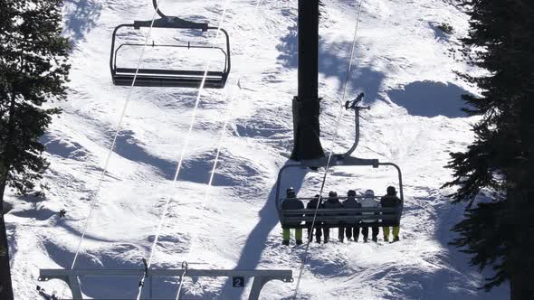 Ski lift with skiers and snowboarders