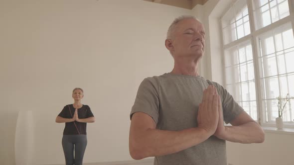 Caucasian Senior Man Meditating at Yoga Class alt