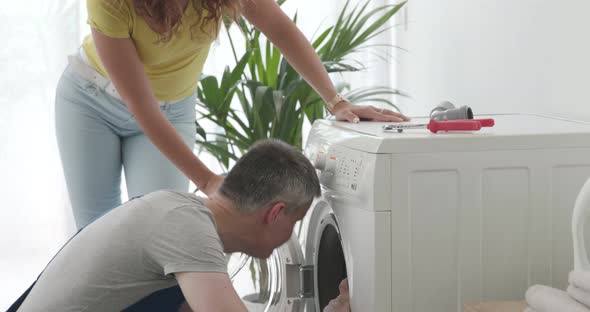 Professional plumber checking a washing machine