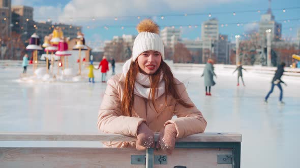Young Smiling Woman Ice Skating Outside on Ice Rink Show Thumbs Up Gesture Christmas Holiday Active alt
