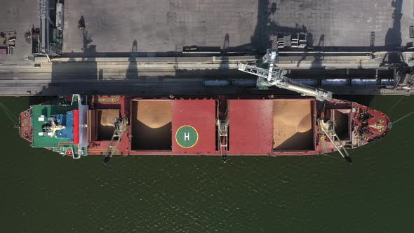 the Camera Looks Vertically Downward While Flying Over a Seagoing Vessel Moored in the Port Under