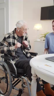 A Woman From Social Care Plays an Elderly Wheelchair User His Favorite Music alt