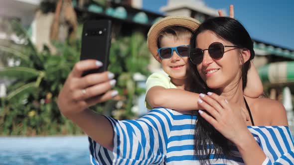 Happy Family Having Fun Taking Selfie Near Swimming Pool Using Smartphone Closeup alt