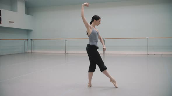Ballerina rotates during rehearsal. Ballet dancer. Pirouette. Ballet pointe shoes. Beautiful rota