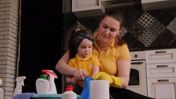 Cheerful Mother and Little Daughter Clean the House Together and Have Fun alt