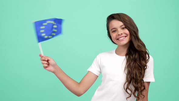 Kid with Cheerful Face Waving European Union Blue Flag Studying Abroad alt