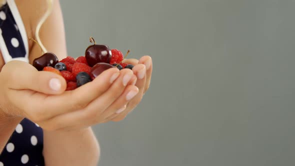 Beautiful woman holding berries alt