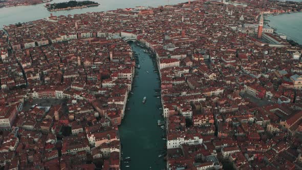 Dolly forward pan down drone shot over Venice Grand canal at dusk alt