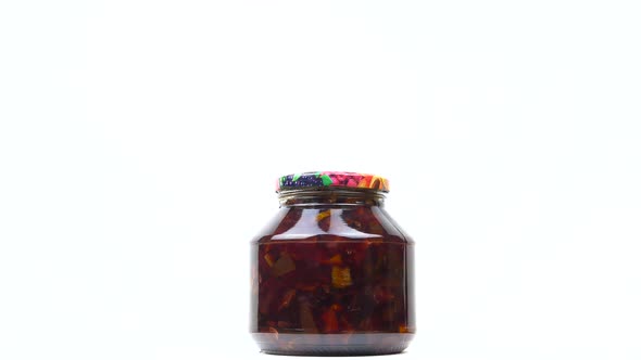 A glass jar of canned apple jam