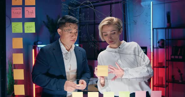 Businesspeople which Working Together Near this Wall with Graphs and Sticky Notes alt