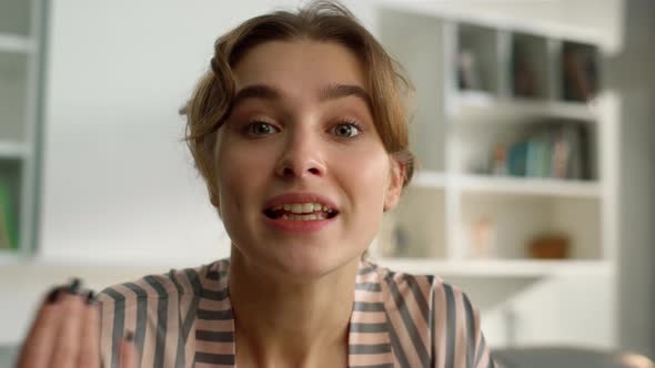 Pretty Girl Sharing Online Making Silence Gesture in Morning Living Room Closeup alt