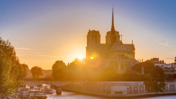 Rear View of Notre Dame De Paris Cathedral at Sunset with Sun in the Frame Timelapse alt