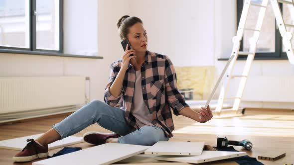Woman Assembling Furniture and Calling on Phone