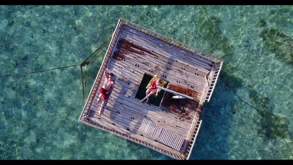 Young couple tan on relaxing coast beach lifestyle by shallow ocean with white sand background of th alt