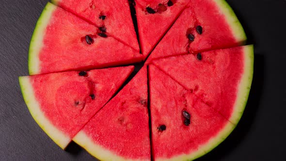 Juicy Pieces of Watermelon Shaped Pizza on a Black Stone Table