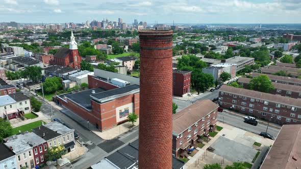 Aerial orbit reveals Baltimore city housing and urban skyline. Sandtown neighborhood. alt
