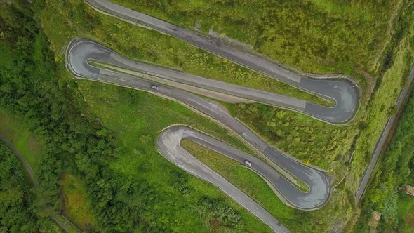 Aerial Top Down Cars Driving on Zig-Zag Winding Serpentine Road, Camera Over Twisted Mountain Road alt
