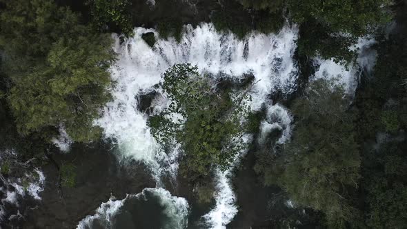 Aerial View of a Multi Tiered Waterfall Nestled in the Forest. alt
