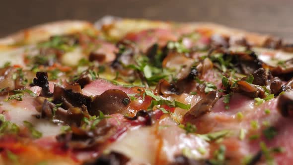 One Salami and Bacon Pizza on Black Slate Platter Rotating alt