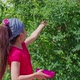 Little Girl is Picking Honeysuckle in Garden - VideoHive Item for Sale