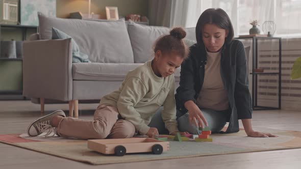 Mother and Little Daughter Playing with Toys Together at Home, Stock Footage