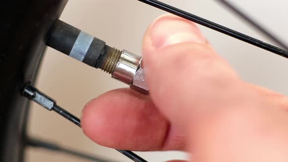 Close Up Closes the Lid on the Bicycle Wheel. Macro Shot alt