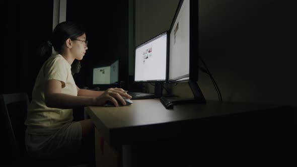 Asian businesswoman write work on a tablet at night in a home office.