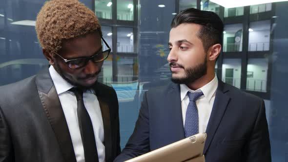 Two businessmen in lift