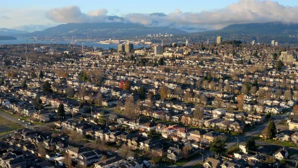 Charming Residential Town In Burnaby Canada With Scenic Mountain Background - aerial shot alt