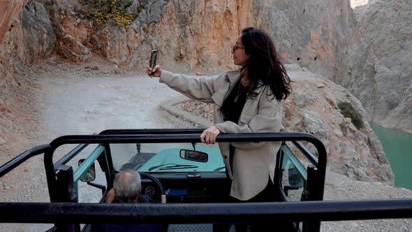 Traveler Tourist In Car Takes Selfie alt