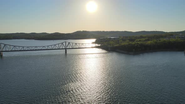 Aerial Birds Following View of a Hige River Bay and the Green Rainforest Under the Setting Sun