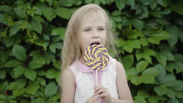 Curly girl with a lollipop