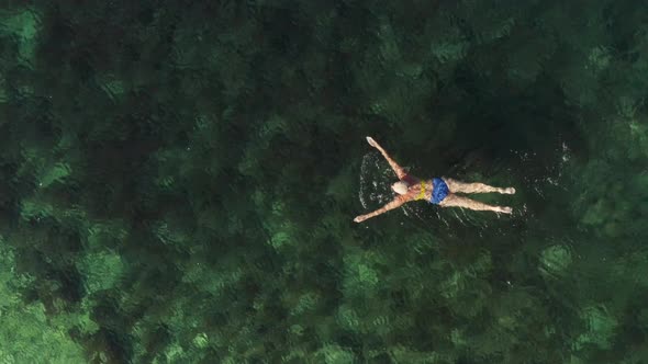 Aerial View of a Woman Swimming in the Sea alt