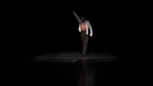 Ballroom Male Dancer on Stage in White Shirtnaked Tanned Torsomoving From Darkness to Floodlight