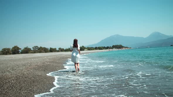 Happy Young Woman Dancing Near Waving Sea